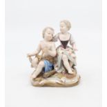 Early 20th century Meissen figure of two young children with a snake on a guilt detail porcelain