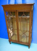 Late George IV display cabinet, glazed front and side on turned peg legs.