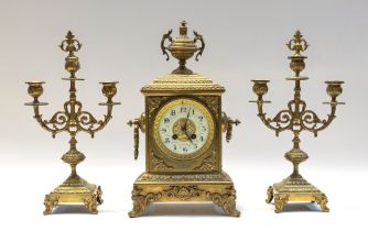 A late 19th century clock garniture, brass cased bracket clock with stylised Nouveau designed dial