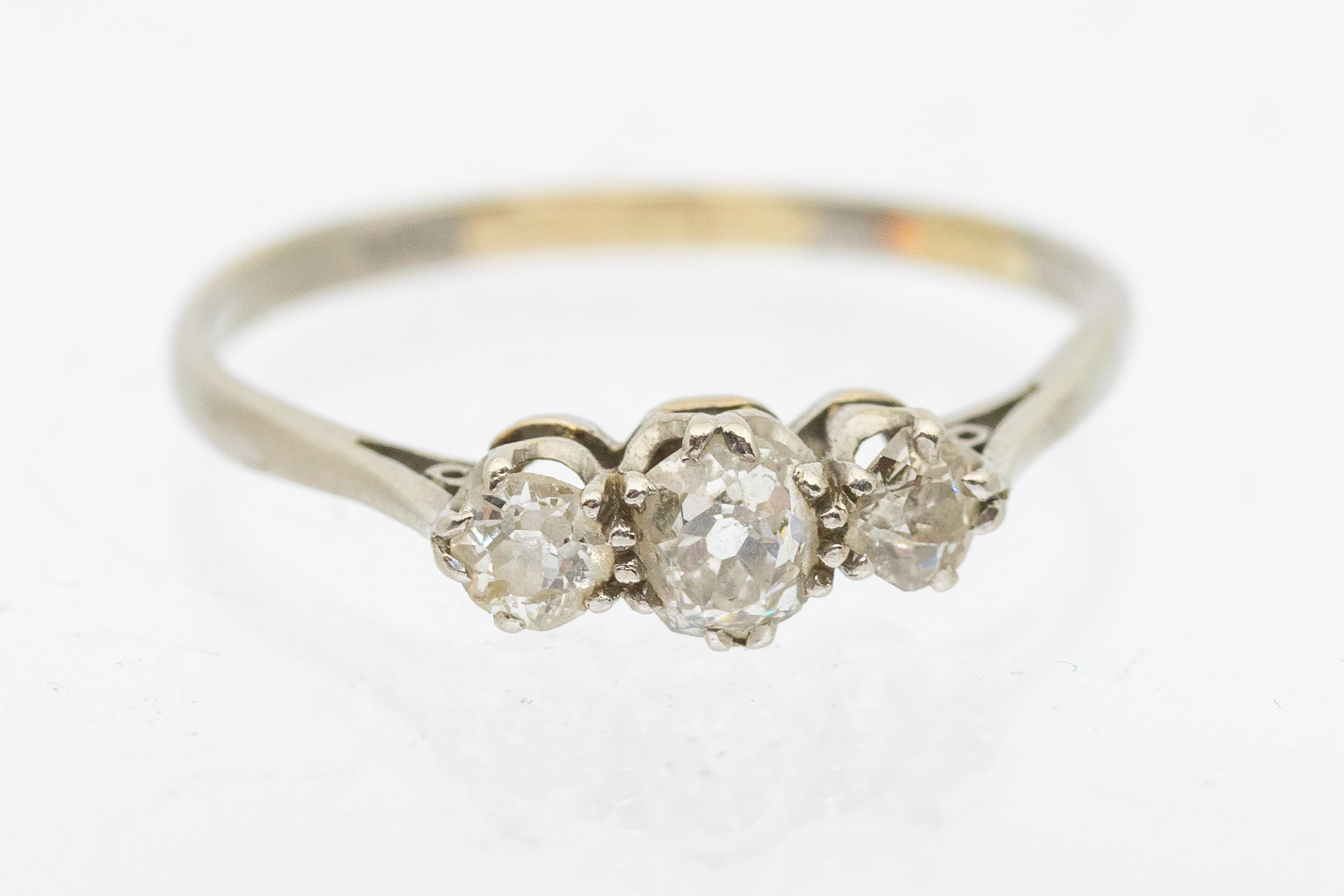 A diamond and platinum three stone ring, comprising graduiated old European cut diamonds, total