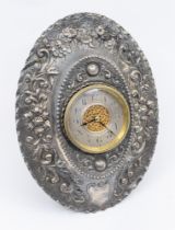 A Victorian silver oval desk clock frame, chased with floral decoration, central circular section