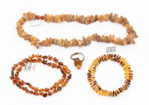 A collection of amber chip beaded jewellery, to include two necklaces, a wired coil bracelet and a