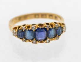 A Victorian sapphire and diamond 18ct gold ring, comprising a central row of graduated cushion cut