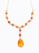 An Amber and 9ct gold necklace, comprising a pear shaped cabochon amber drop, approx 18 x 12mm,