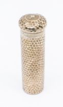 A late Edwardian hammered silver long toilet bottle, screwable top and gilt interior. With