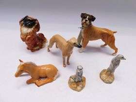 Three boxed Beswick dogs, boxer, pekingnese, whippet along with a small boxed pony and two boxed