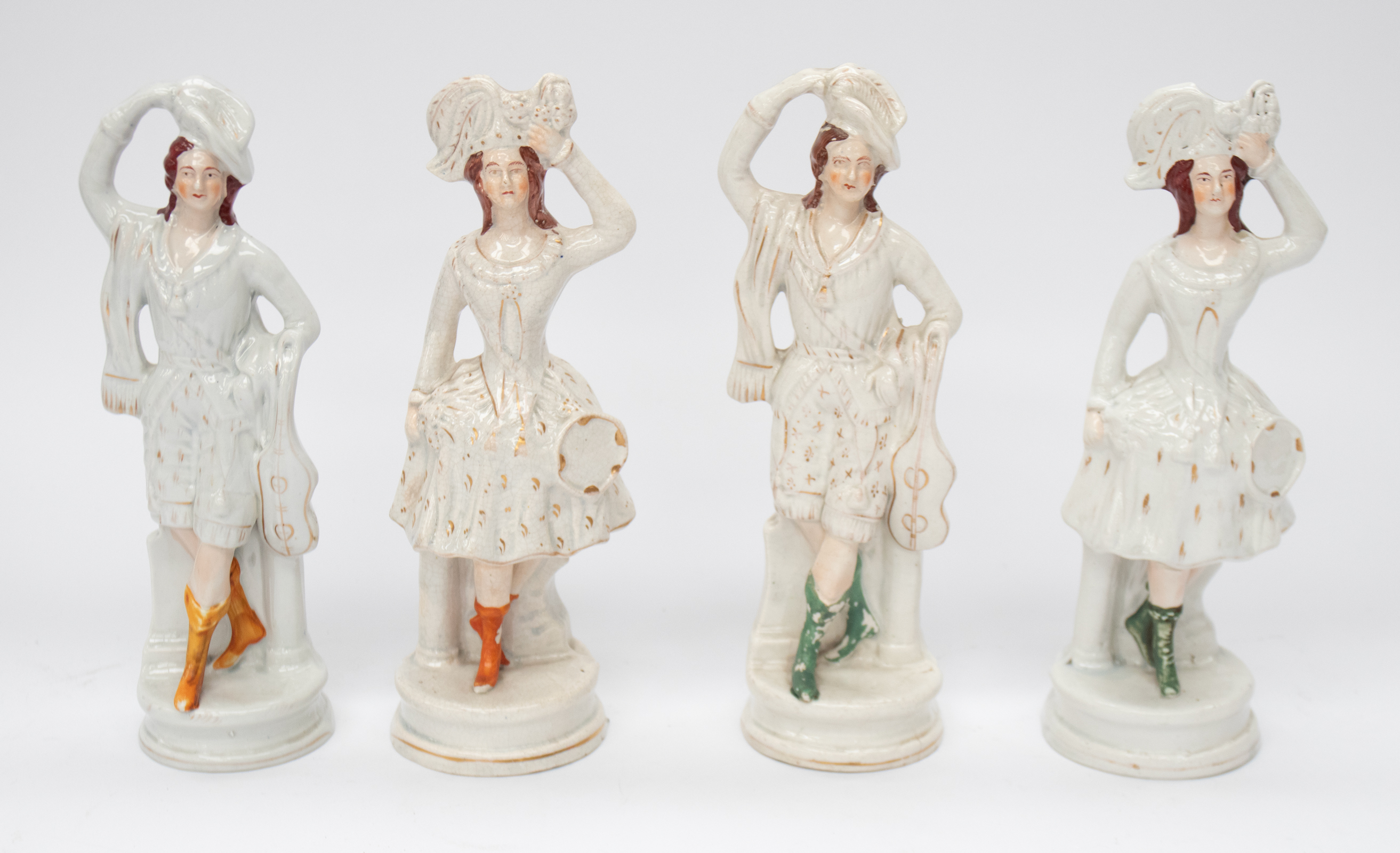 Four similar Staffordshire figures, all Ladies in white dress and hand on hats. Some cracking, wear,