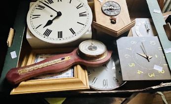 A box of various wall clocks and barometers