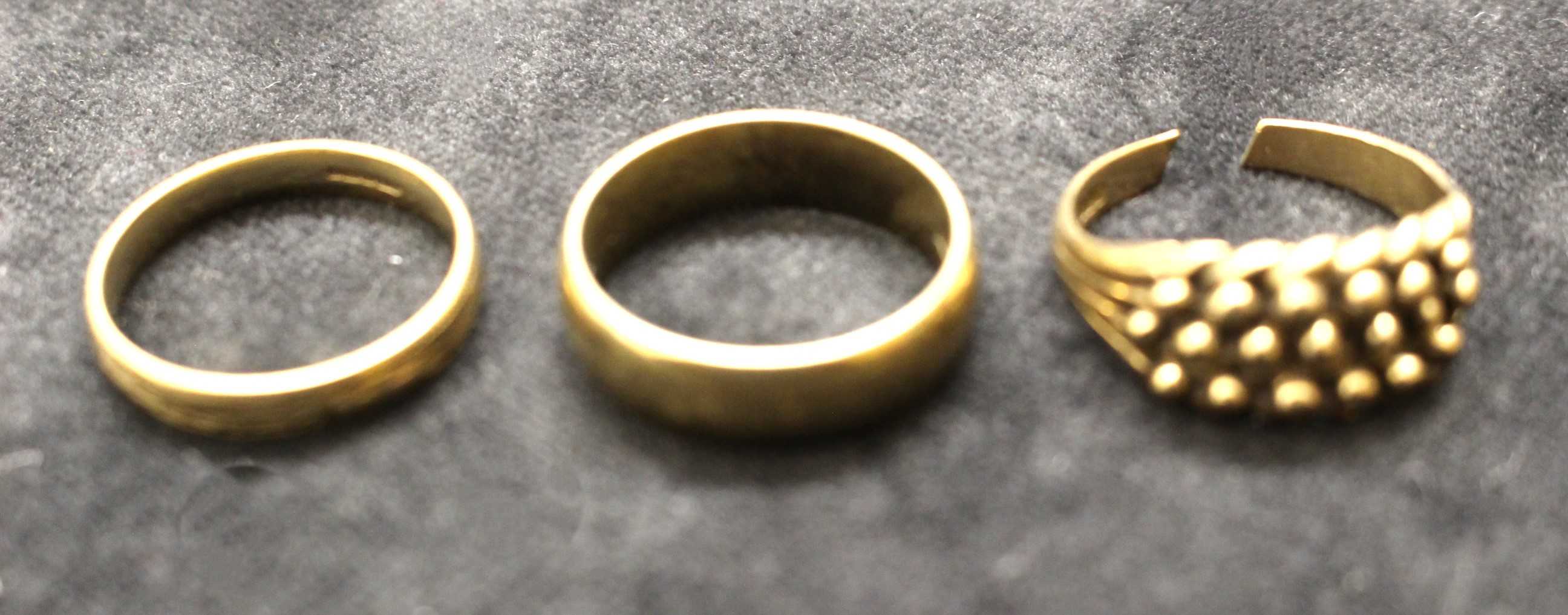 Three 9ct Gold rings. Two of them are weddings band. One of them is ring size S and the other one is
