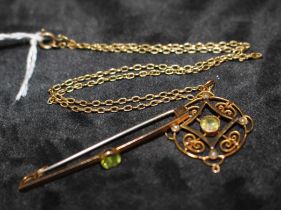 '9CT' hallmarked Art Nouveau Peridot and seed pearl pendant on an unmarked yellow metal chain and