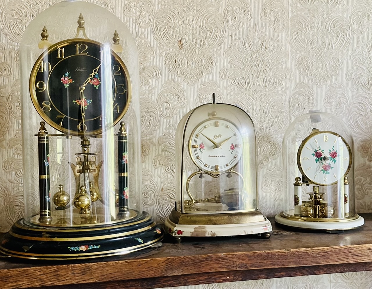 A 20th century brass and glass Kieninger & Oberofell anniversary clock; another by S.Haller,