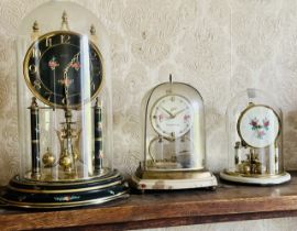 A 20th century brass and glass Kieninger & Oberofell anniversary clock; another by S.Haller,