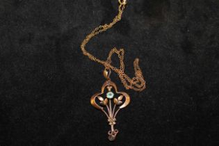 '9CT' hallmarked Art Nouveau bluish green stone pendant on an unmarked yellow metal fine chain.  The