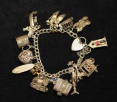 Sterling Silver Charm bracelet with 15 white metal charms including Holy Bible, Car and Donald Duck.