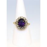 18ct Yellow Gold Oval Faceted Amethyst and Diamond Cluster Ring. Amethyst size 10.21mm height by 7.