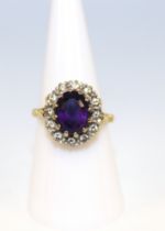 18ct Yellow Gold Oval Faceted Amethyst and Diamond Cluster Ring. Amethyst size 10.21mm height by 7.