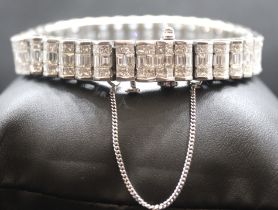 A diamond panel bracelet set with an estimated 19.45 carats of diamonds, in white metal stamped