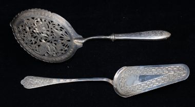 A white metal pierced and engraved spoon with oval shallow bowl and a similar style slice, both