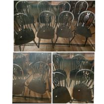 Set of eight wheel back dark oak chairs including two carvers. (8)