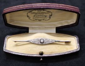 An Art Deco 14ct Gold '585' stamped gold bar brooch with approx 0.20ct centre old cut diamond with