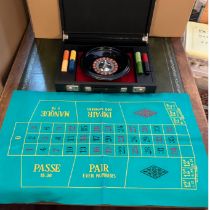 Roulette wheel, counters and mat housed in a black brief case.