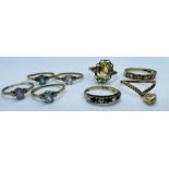 A collection of eight gem set dress rings. Two hallmarked, five stamped "9ct" and one unmarked.