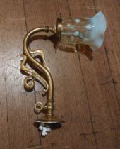 A Single wall hanging Arts and Crafts style brass light fitting with yellow Vaseline glass shade