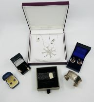 A selection of silver and white metal jewellery comprising a modernist pendant, four pairs of