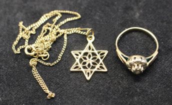 A 9ct old diamond ring along with a filigree star pendant on a 9ct gold chain. The diamond ring
