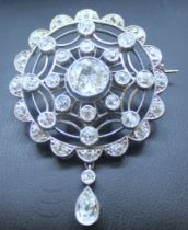 White metal unmarked 1.25ct old cut solitaire diamond brooch with surrounding old cut diamonds.