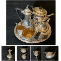 A George V five piece silver tea and coffee service of partly wrythen form comprising teapot and