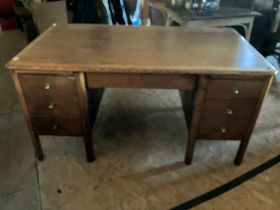 Oak twin pedestal desk with twin pull out returns and lockable centre drawer, brass furniture and