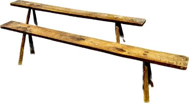 A near pair of oak/elm rustic benches, single plank raised on splay supports. 50cm H x 226cm W x