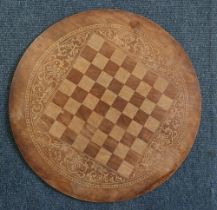 A French inlaid chess board mounted in a circle with foliate inlaid panels, the reverse stamped "