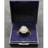 18ct yellow gold opal and diamond cluster ring.  Opal is approx 7mm height by approx 5mm width and