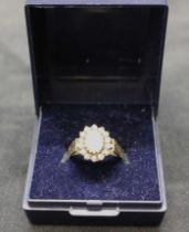 18ct yellow gold opal and diamond cluster ring.  Opal is approx 7mm height by approx 5mm width and