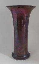 A Moorcroft lily vase in purple lustre, C1920 -1930, Impressed Moorcroft Burslem. Measures 25 cm