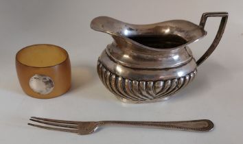 A George Nathan & Ridley Hayes creamer in  silver , hallmarked Birmingham, a child's silver fork,