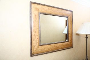 A decorative wall mirror with floral frame, modern, the broad cushion frame with a band of