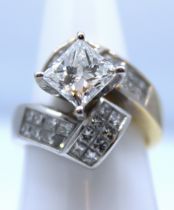 A diamond set crossover ring set with a princess cut diamond of an estimated 2.04 carats in a