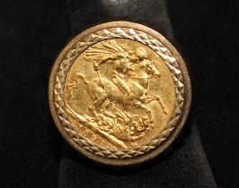 An 1897 Victoria (Veil head) Sovereign ring. Featuring the coin in a 9ct gold (hallmarked) clip