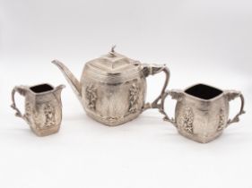 A Victorian silver three piece Indian style tea set comprising teapot, sugar bowl and cream jug, the