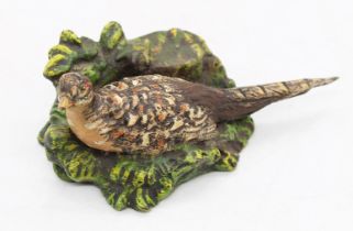 A 20th century cold painted bronze figure of a Hen Pheasant resting within foliage, unsigned, approx