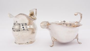 A Georgian silver Helmut shaped milk jug, having engraved design and vacant cartouche to front,