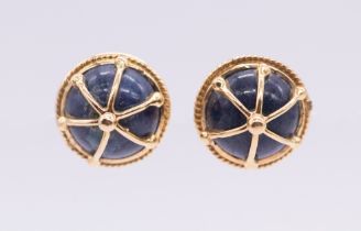 A pair of continental lapis lazuli and gold stud earrings, comprising a round cabochon lapis
