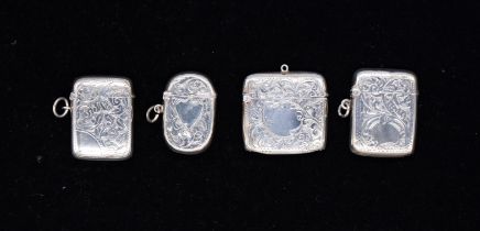 A group of four late 19th / early 20th Century silver vesta cases, each profusely engraved with