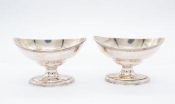 A pair of George III silver salts, boat shaped with reeded rims, each engraved with an initial and