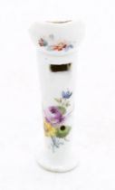 A Meissen style Continental porcelain whistle, the white ground painted floral and foliage design,