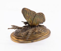 A Victorian novelty figural brass desk top letter holder cast in the form of a butterfly on a