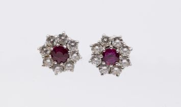 A pair of ruby and diamond 18ct white gold cluster earrings, the centre set with a round mixed cut